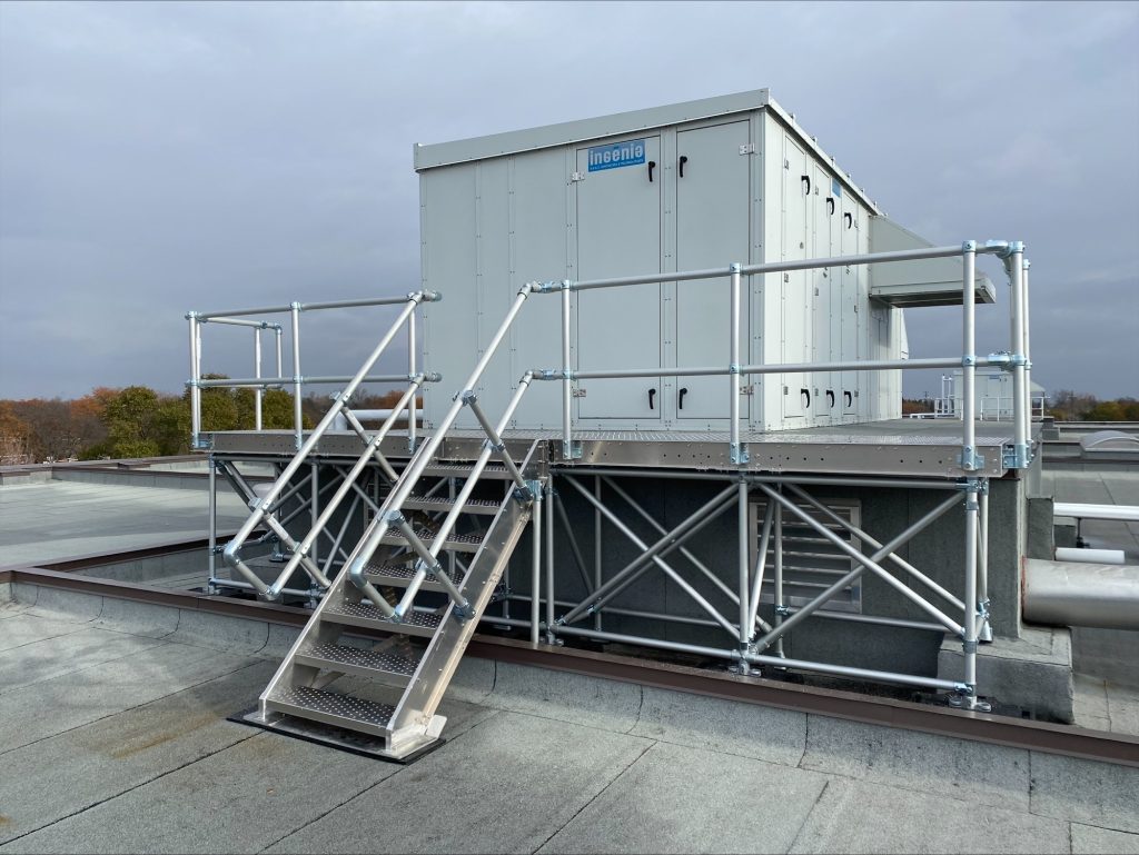 Fully customized freestanding aluminum platform designed to facilitate access to the unit requiring maintenance on this school board's flat roof.