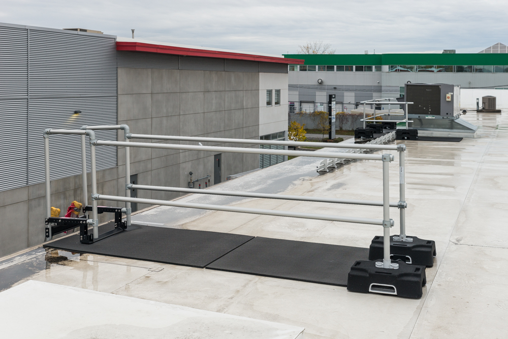 A ladder stabilizer system is installed on a rooftop
