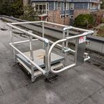 Roof hatch with fall protection railing