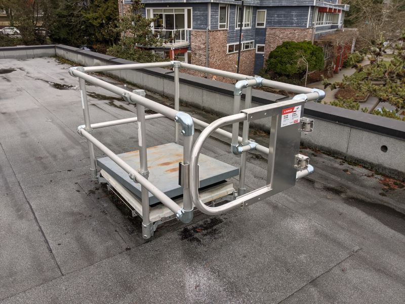 Roof hatch with fall protection railing
