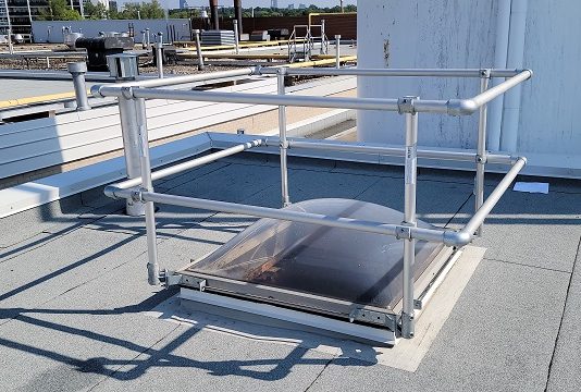 Guardrail installed around a rooftop skylight