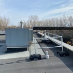 Rooftop guardrail installed around HVAC unit