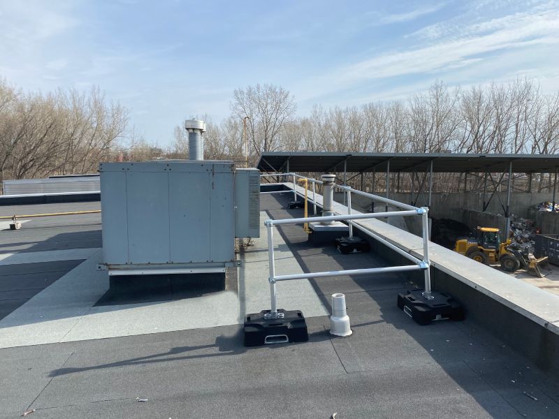 Rooftop guardrail installed around HVAC unit