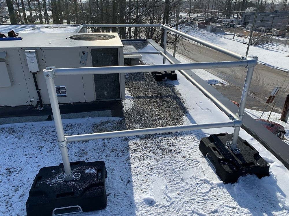 Rooftop safety railing protection working along HVAC uinit on roof